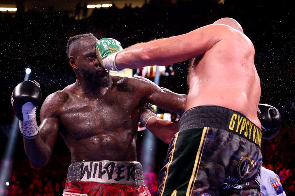 LAS VEGAS, NEVADA - OCTOBER 09: Tyson Fury (R) punches Deontay Wilder during their WBC heavyweight title fight at T-Mobile Arena on October 09, 2021 in Las Vegas, Nevada. (Photo by Al Bello/Getty Images)