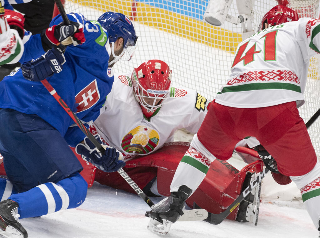 Slovenský hokejista Tomáš Jurčo (vľavo), bieloruský brankár Danny Taylor (uprostred) a bieloruský obranca Kirill Gotovec (vpravo) bojujú o puk v poslednom zápase D-skupiny Slovensko - Bielorusko na kvalifikačnom turnaji o postup na ZOH2022 v Pekingu v Bratislave v nedeľu 29. augusta 2021. FOTO TASR - Martin Baumann