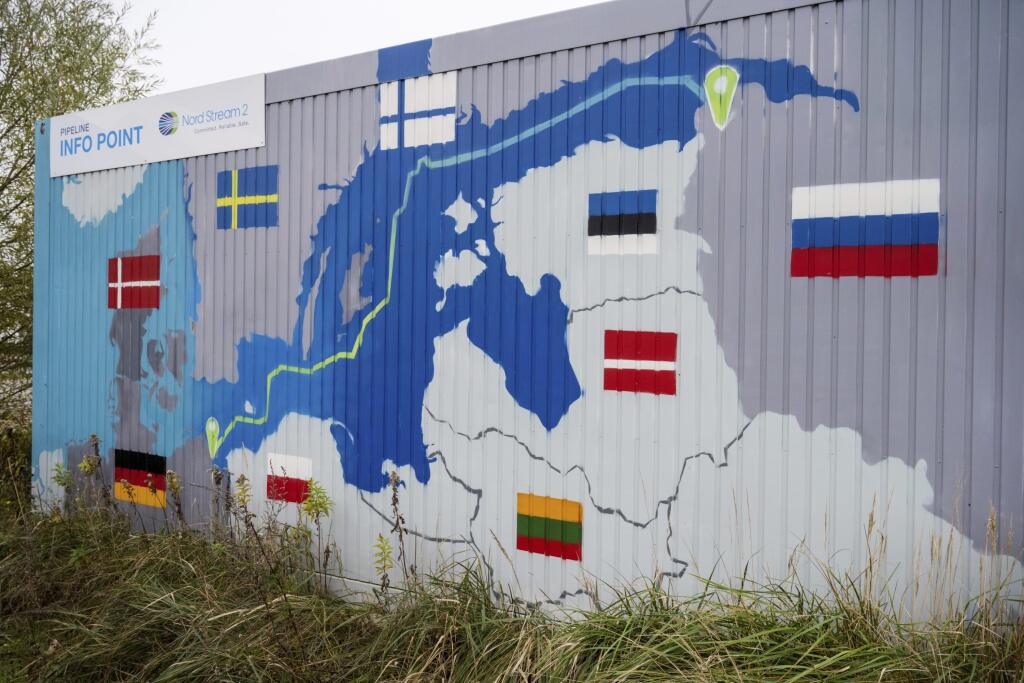 In the picture, a sign with the words Nord Stream 2 hangs over a painted map on November 16, 2021 in Lubmin, Germany.  The German Network Authority stated that it had suspended the certification process for the North Stream 2 gas pipeline project. As a reason, it stated that the structure of the company operating the pipeline was not yet in line with German law.  The decision of the German authority represents a new complication for the project worth 10 billion euros.