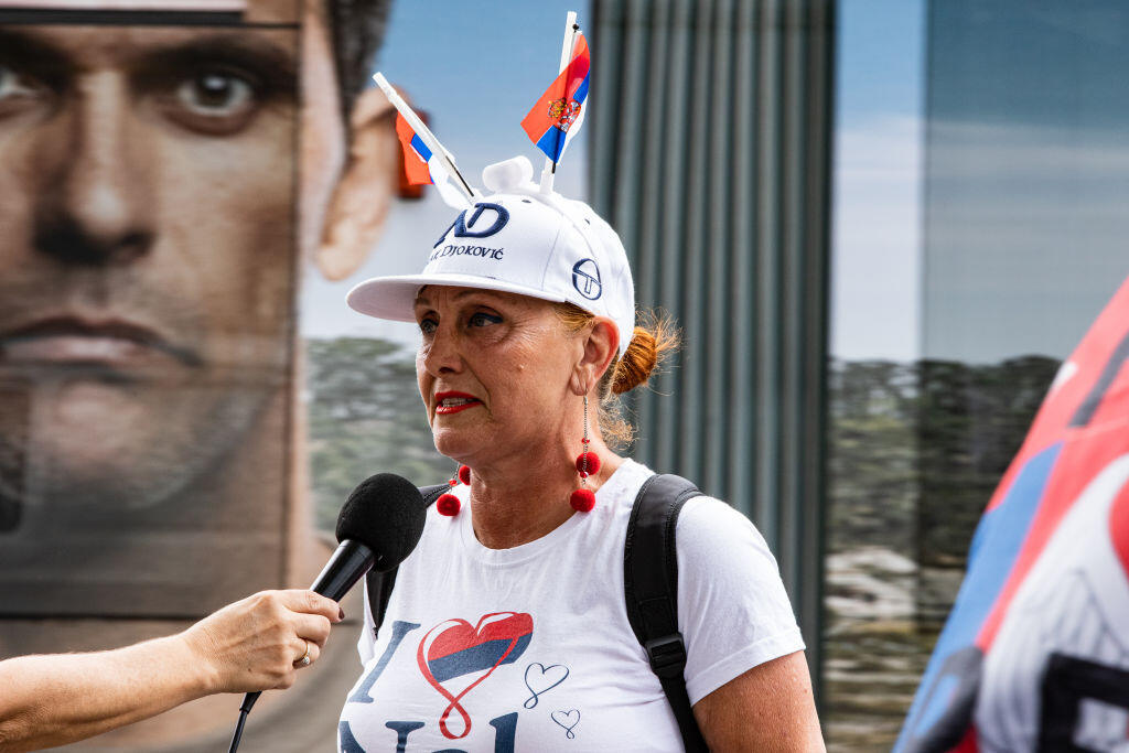 MELBOURNE, AUSTRALIA - JANUARY 08: Serbian tennis fans and anti vaccination protesters rally outside the Park Hotel on January 08, 2022 in Melbourne, Australia. Djokovic arrived in Melbourne to play in the upcoming Australian Open and was denied entry to Australia due to his inability to meet Australian entry requirements. He is currently in an immigration detention hotel awaiting a hearing challenging his deportation. (Photo by Diego Fedele/Getty Images)