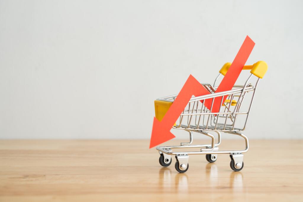 Shopping,Trolley,With,Red,Chart,Falling,Down,On,Wooden,Table
