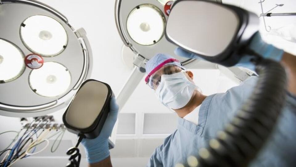 Surgeon Holding Defibrillator
