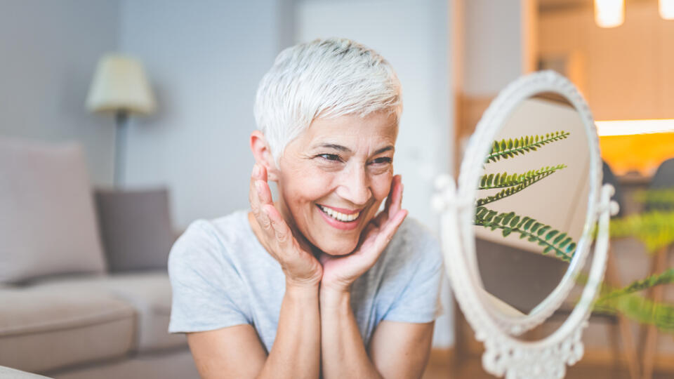 Cropped,Shot,Of,A,Mature,Woman,Inspecting,Her,Skin,In