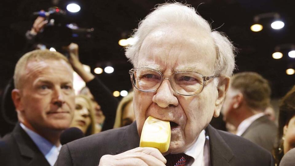 Berkshire Hathaway Chairman and CEO Warren Buffett eats an ice cream bar while touring the exhibition floor prior to the annual shareholders meeting on Saturday, May 3, 2014, in Omaha, Neb. More than 30,000 shareholders are expected to fill the CenturyLink Arena to hear Buffett and Berkshire Vice Chairman Charlie Munger discuss their business. (AP Photo/Nati Harnik)