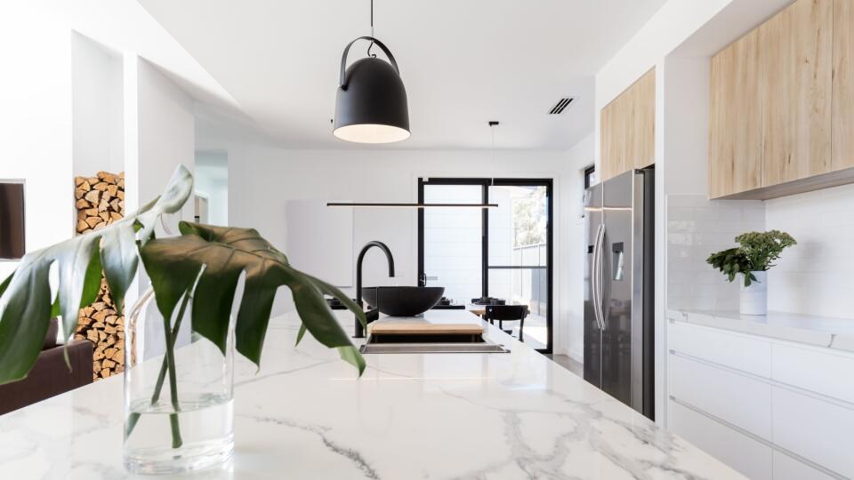 Kitchen marble bench close up with black hanging pendant