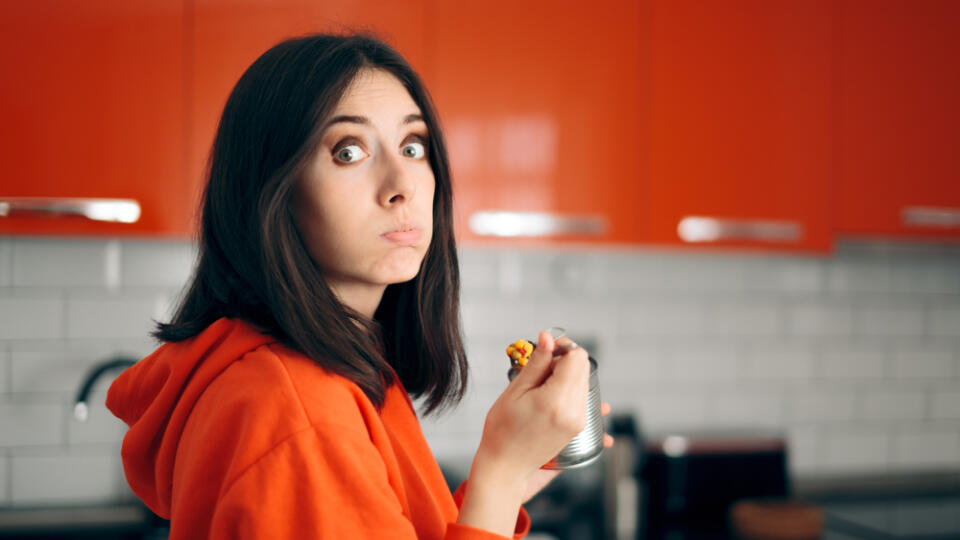 Sad,Bored,Woman,Eating,From,A,Can,In,The,Kitchen.