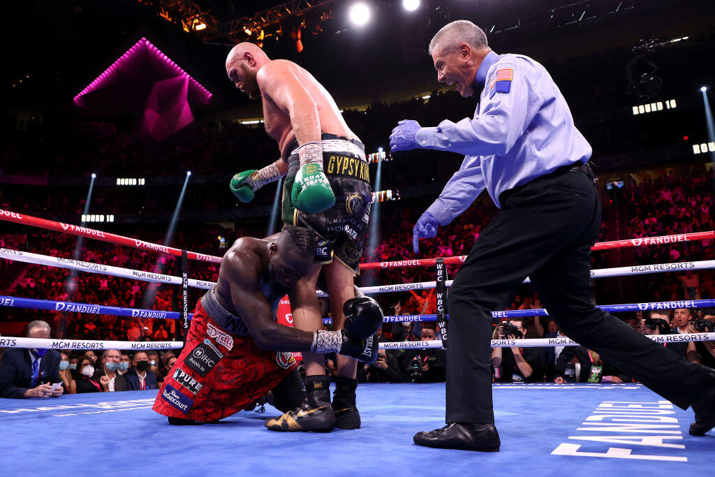 LAS VEGAS, NEVADA - OCTOBER 09: Tyson Fury (top) knocks down Deontay Wilder in the 10th round during their WBC heavyweight title fight at T-Mobile Arena on October 09, 2021 in Las Vegas, Nevada. (Photo by Al Bello/Getty Images)