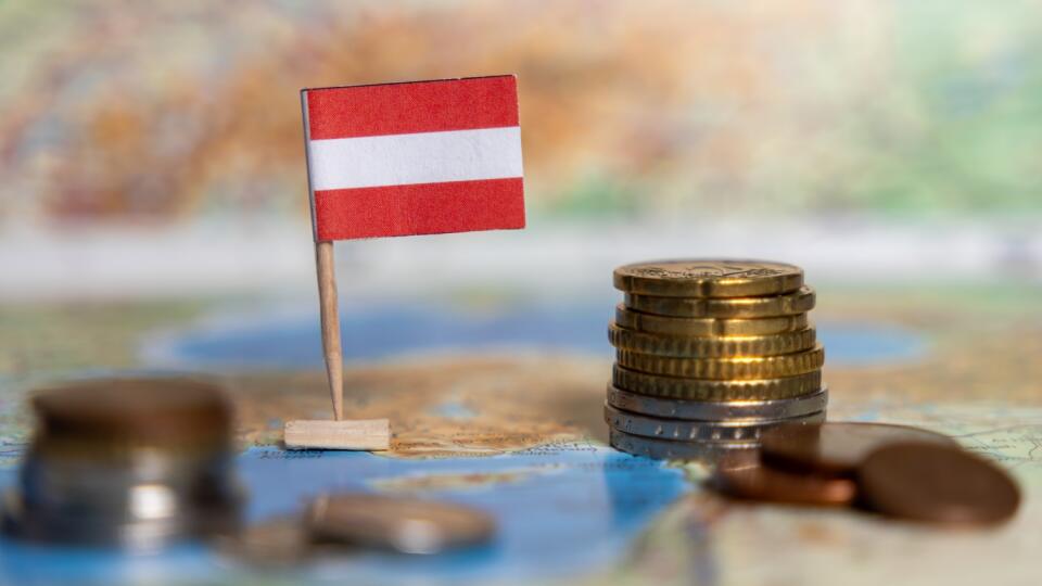 austrian flag on map with stacked coins in the foreground, symbolizing austria's economy, financial growth, banking sector, investments, and trade opportunities