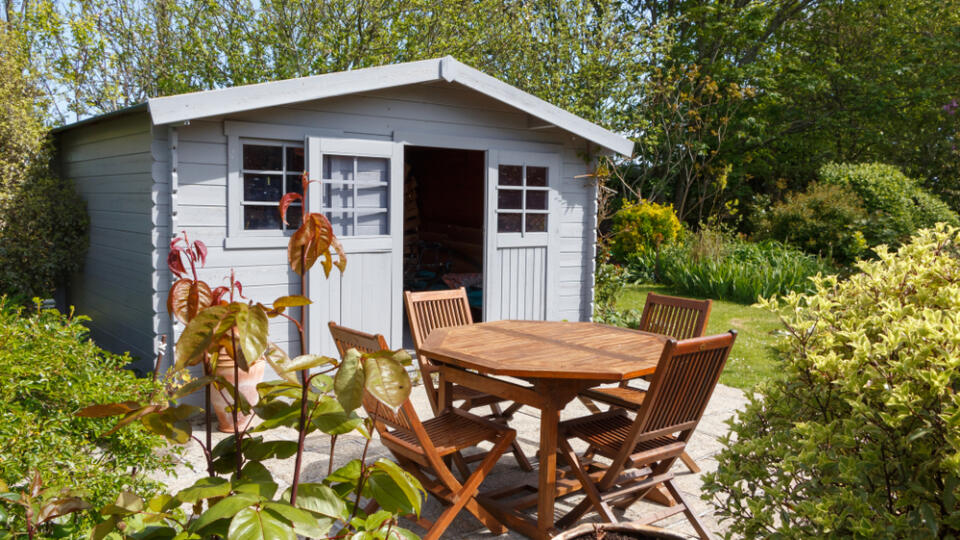 Grey,Shed,With,Terrace,And,Wooden,Garden,Furniture,In,A