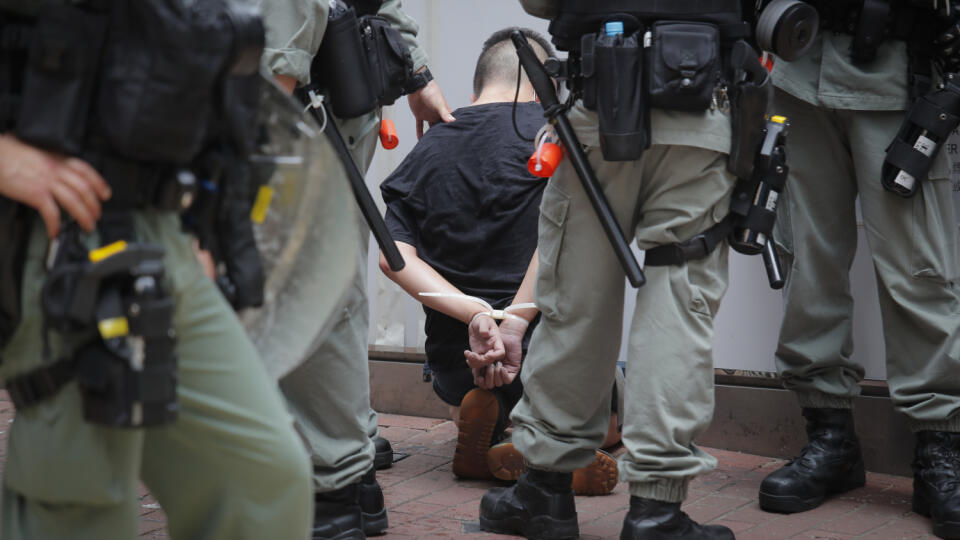 WA 5 Hongkong - Policajti zatkli demonštranta, ktorého tvár zasiahol paprikový sprej pred slávnostným zhromaždením pri príležitosti 23. výročia prechodu Hongkongu pod čínsku správu v Hongkongu 1. júla 2020. Británia v roku 1997 odovzdala Hongkong Číne. Hongkong si výročie prechodu pod čínsku správu pripomína len deň po schválení kontroverzného zákona o národnej bezpečnosti pre Hongkong, ktorý schválil stály výbor Celočínskeho zhromaždenia ľudových zástupcov (parlament). FOTO TASR/AP
Police de