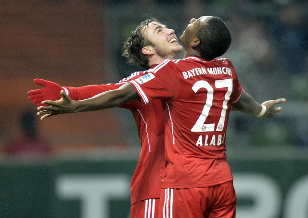 Bayern's scorer Mario Goetze, left, celebrates his goal with Bayern's David Alaba of Austria during the German Bundesliga soccer match between Werder Bremen and Bayern Munich in Bremen, Germany, Saturday, Dec. 7, 2013. Bayern defeated Bremen with 7-0. (AP Photo/Martin Meissner)