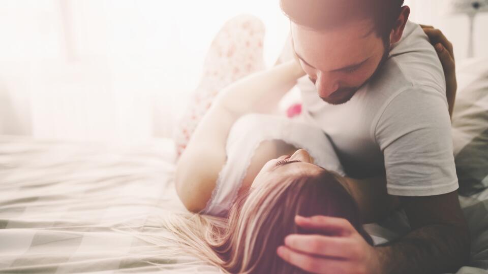 Sensual romantic foreplay by couple in love in bed