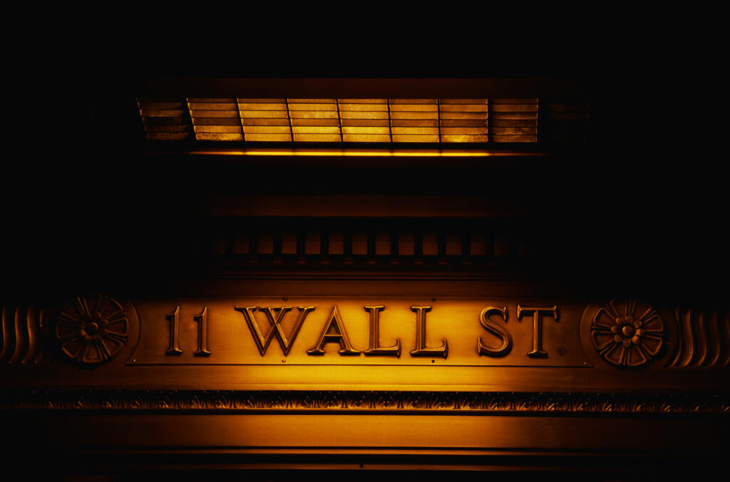 This is a sign on the outside of the New York Stock Exchange that says Wall Street. 