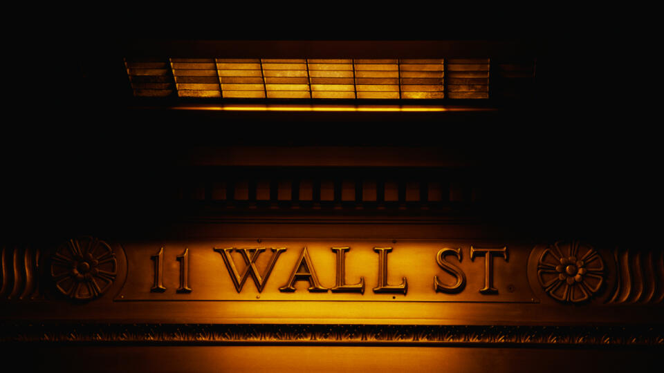 This is a sign on the outside of the New York Stock Exchange that says Wall Street.