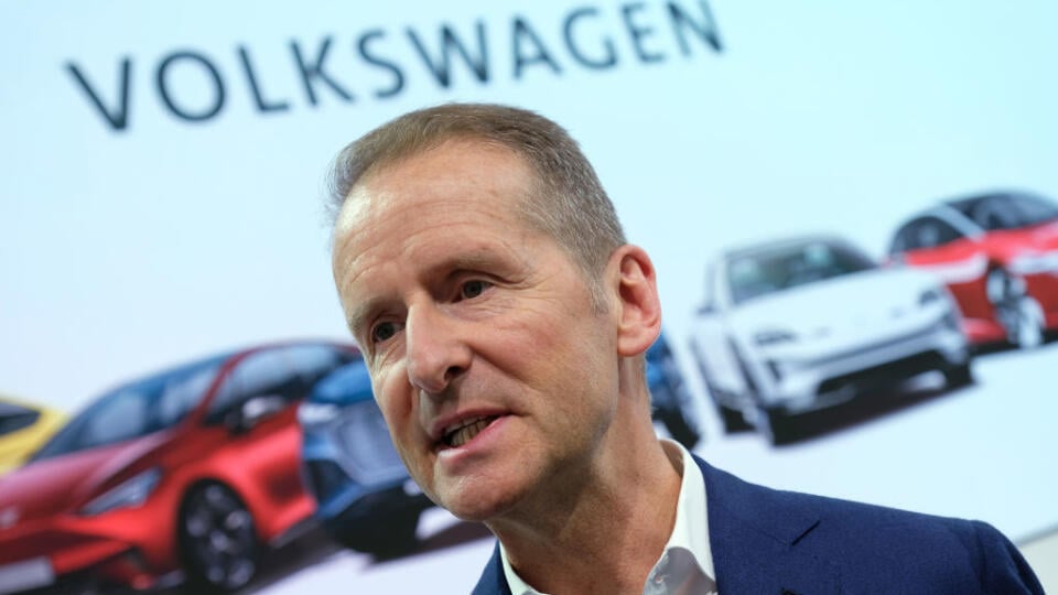 WOLFSBURG, GERMANY - MARCH 12: Herbert Diess, CEO of German automaker Volkswagen AG, stands in front of pictures of electric cars from the various VW-owned brands following the company's annual press conference at Volkswagen headquarters on March 12, 2019 in Wolfsburg, Germany. Diess said he is committing the company to an electric car future and has set ambitious greenhouse gas reduction goals for the VW by aiming to make the entire company CO2 neutral by 2050. (Photo by Sean Gallup/Getty Image