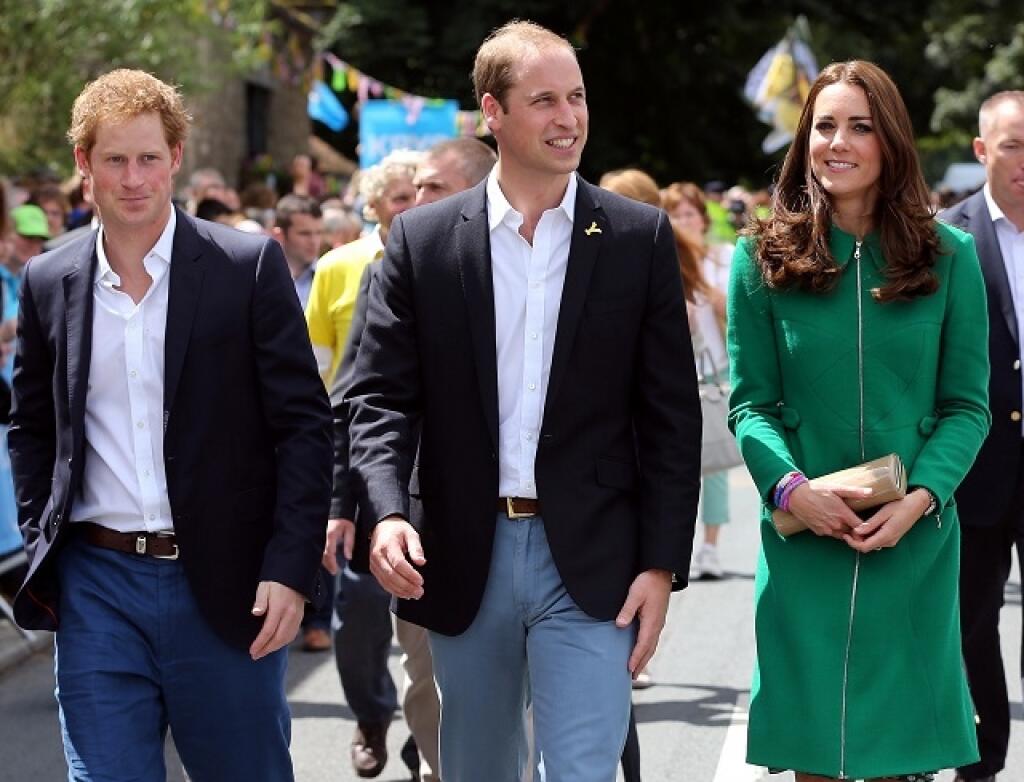 Prince William, centre, Kate Duchess of Cambridge and Prince Harry walk along the street to celebrate the start of the Tour de France in Yorkshire at West Tanfield, England, Saturday, July 5, 2014. The 198 competitors in the 101st Tour de France have started their grueling three-week ride through four countries before ending the world's greatest cycling race in Paris on July 27. (AP Photo/Scott Heppell/Pool)