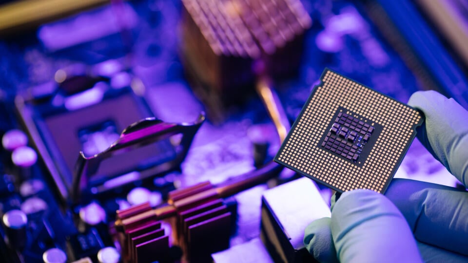 Engineer,Showing,A,Computer,Microchip,On,Motherboard,Background.,Electronic,Circuit