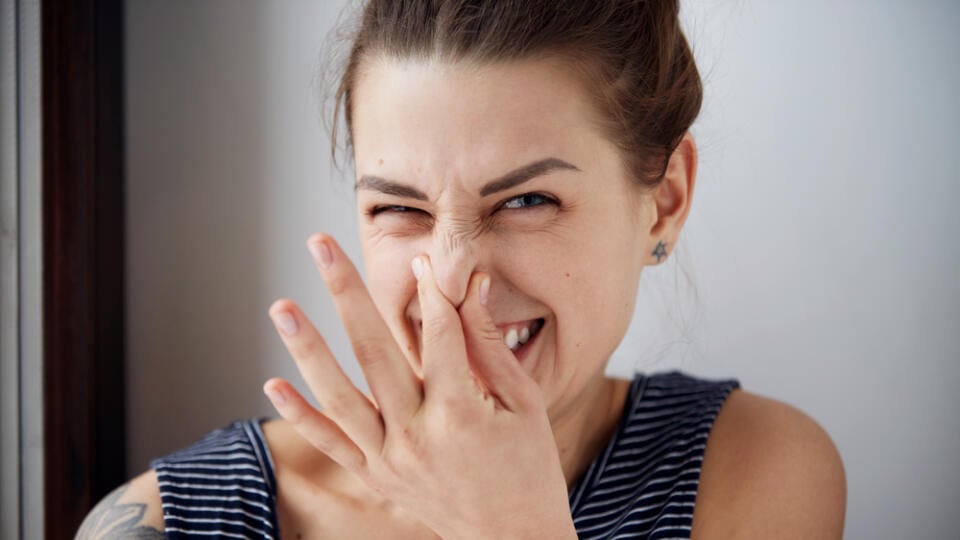 Female,Gesture,Smells,Bad.,Headshot,Woman,Pinches,Nose,With,Fingers