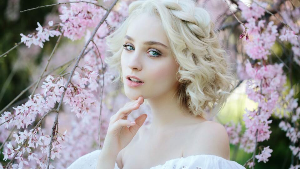 Beautiful girl on the background of spring bush