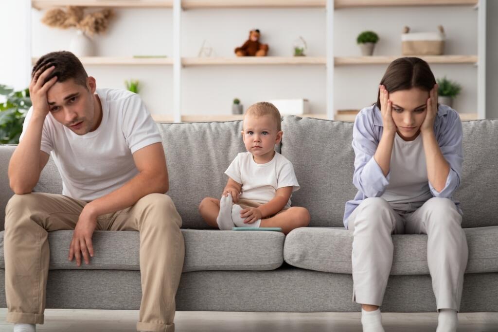 Family,Conflicts.,Cute,Infant,Baby,Sitting,Between,Offended,Parents,After