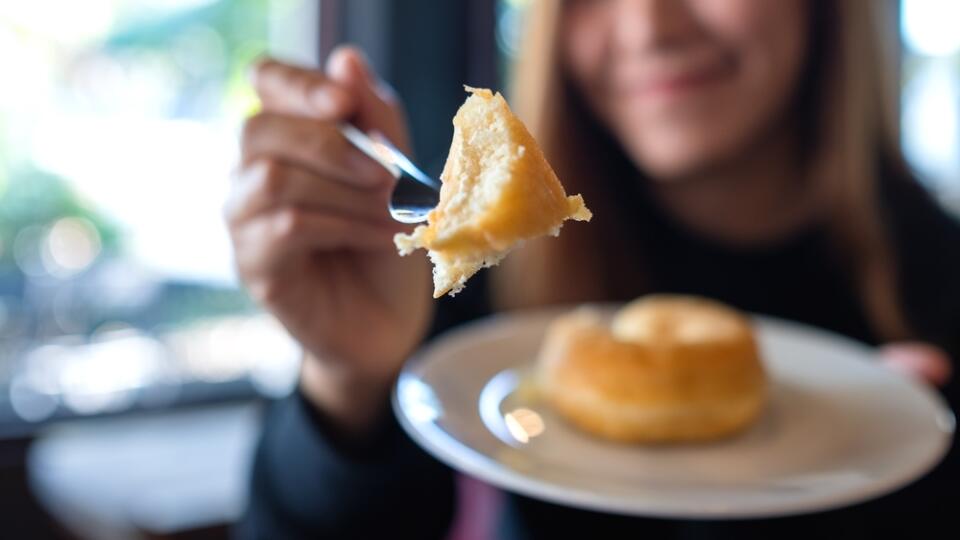 Closeup,Of,A,Young,Woman,Holding,And,Giving,A,Donut