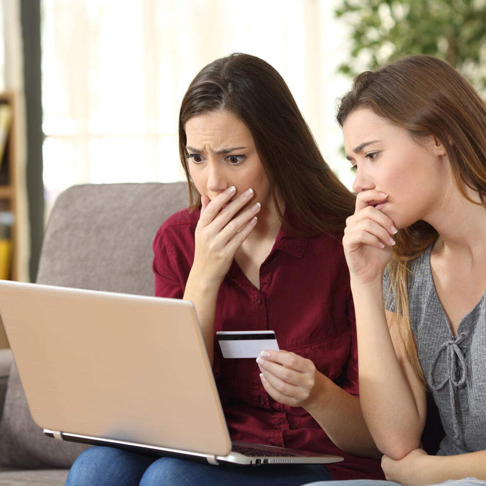 Two,Worried,Friends,Having,Problems,Buying,On,Line,With,Credit