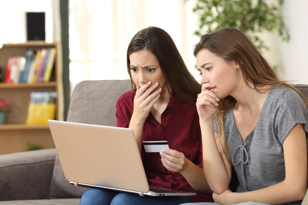 Two,Worried,Friends,Having,Problems,Buying,On,Line,With,Credit