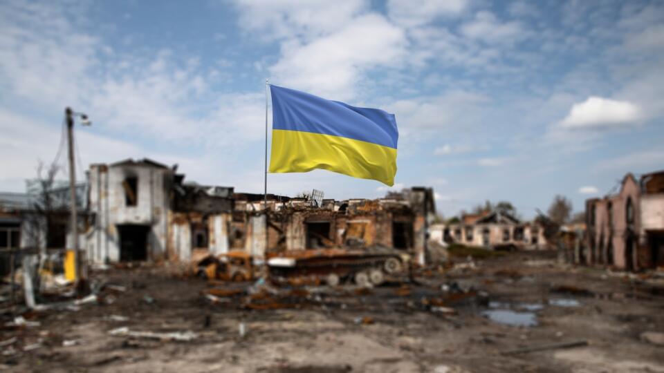 Ukrainian,Flag,In,Front,Of,War-torn,Ruins,Under,A,Clear