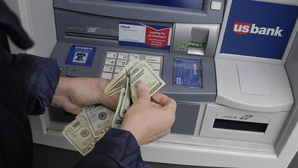 Female cash money fro USbank's atm cash machine