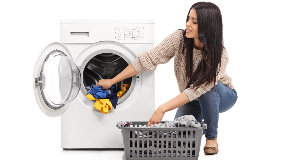 Young,Woman,Emptying,A,Washing,Machine,Isolated,On,White,Background