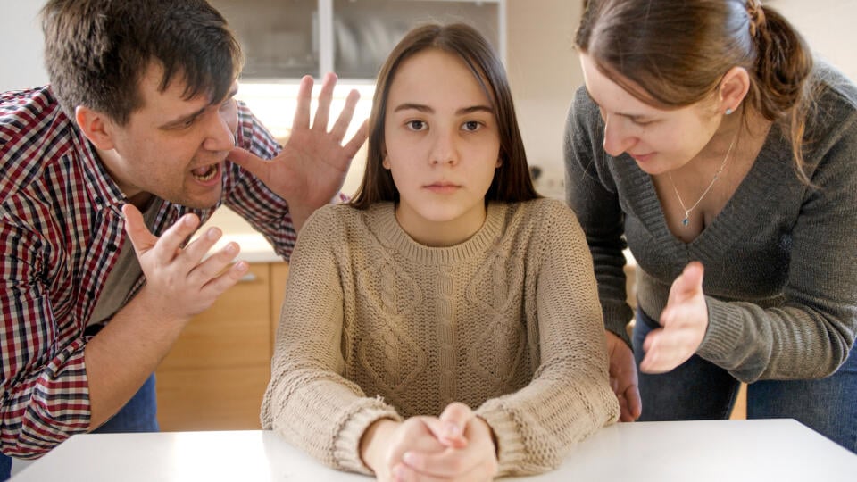 Parents,Yelling,And,Shouting,At,Teenage,Daughter,Sittin,Behind,Table