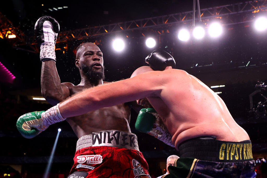 LAS VEGAS, NEVADA - OCTOBER 09: Deontay Wilder (L) and Tyson Fury exchange punches during their WBC heavyweight title fight at T-Mobile Arena on October 09, 2021 in Las Vegas, Nevada. (Photo by Al Bello/Getty Images)