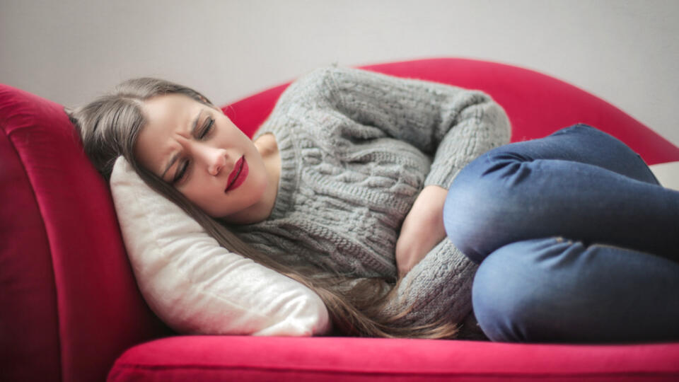 Young,Girl,With,Stomach,Pain,Lying,On,The,Sofa