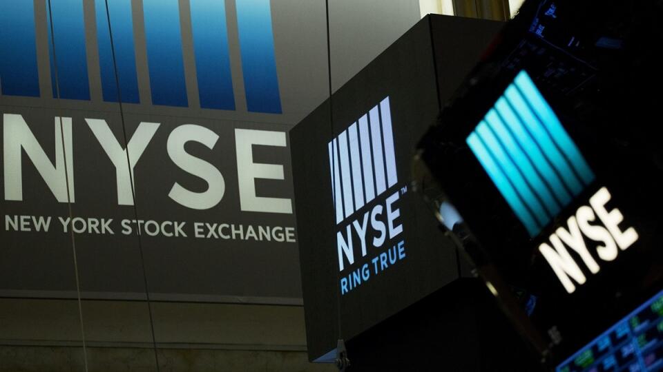 In this Thursday, May 10, 2018, photo, signs for the New York Stock Exchange hang above the trading floor. The NYSE has named its first female leader in the history of the 226-year-old exchange. The parent company of the NYSE, Intercontinental Exchange Inc., told The Wall Street Journal late Monday, May 21, 2018, that Stacey Cunningham will become the 67th president. She’s currently NYSE’s chief operating officer. Cunningham will start her new job on Friday, May 25. She succeeds Thomas Farley, w