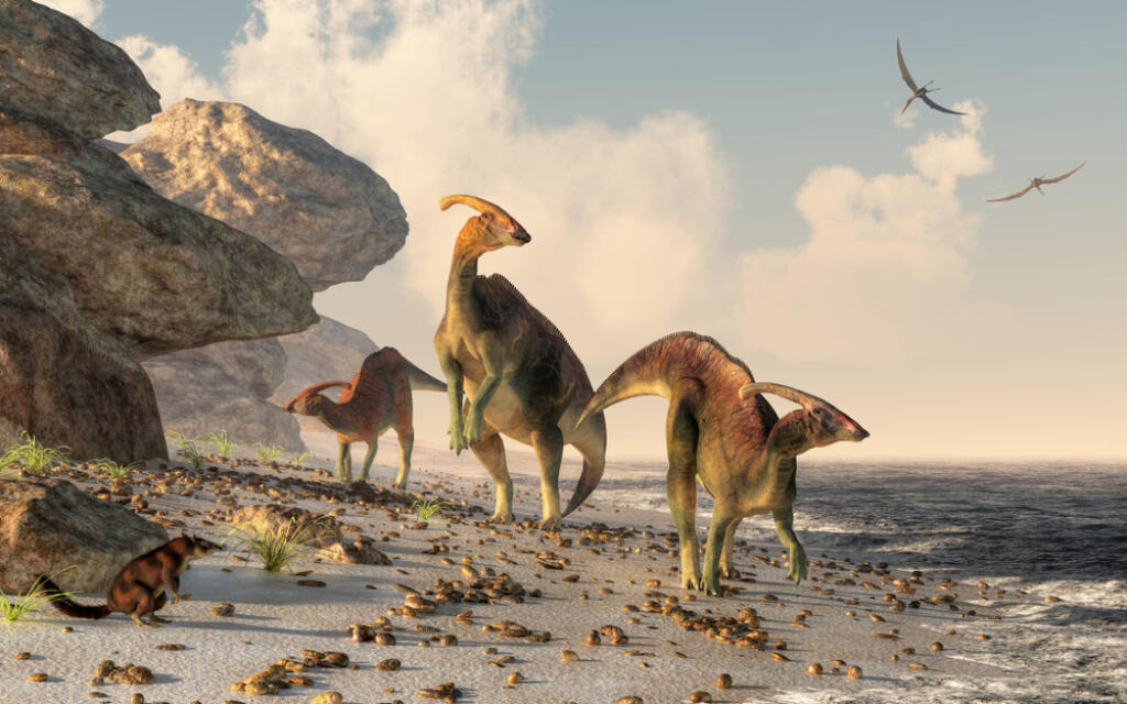 Three,Parasaurolophus,Stand,On,A,Rock,Beach.,Pterasaurs,Fly,Over