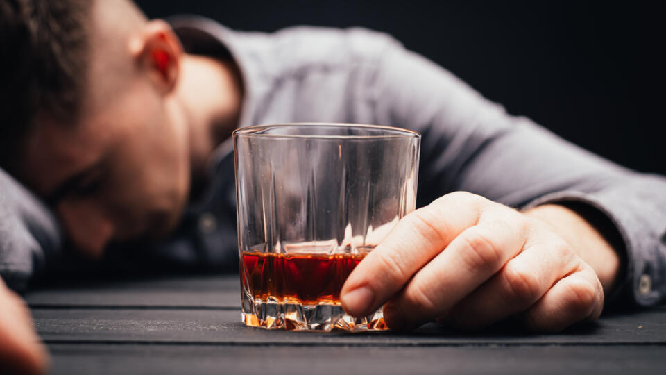 Unconscious,Drunk,Man,With,Glass,Of,Whiskey,At,Table