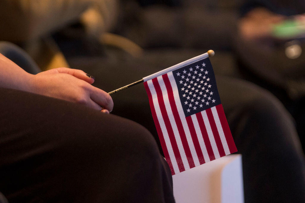 BOSTON, MA - FEBRUARY 08:  A woman holds an American flag during a Naturalization Oath Ceremony at the John F. Kennedy Presidential Library and Museum on February 8, 2017 in Boston, Massachusetts.  (Photo by Scott Eisen/Getty Images)