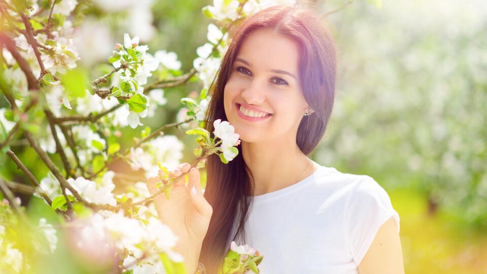 happy young women in the garden with apple flowers