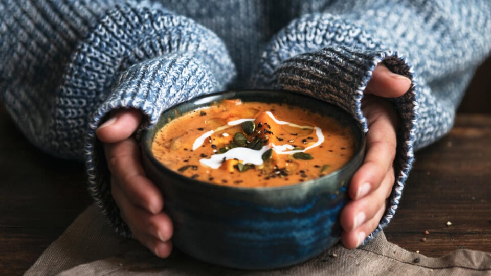 Female,Hands,Holding,A,Bowl,Of,Pumpkin,Soup