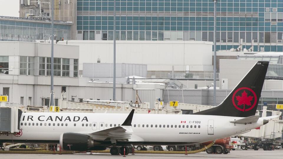 An Air Canada Boeing 737 Max 8 aircraft is parked next to a gate at Trudeau Airport in Montreal, Wednesday, March 13, 2019. Canada's transport minister says the country is closing air space to the Boeing 737 Max 8 jet following the crash of an Ethiopian Airlines jetliner. (Graham Hughes/The Canadian Press via AP)