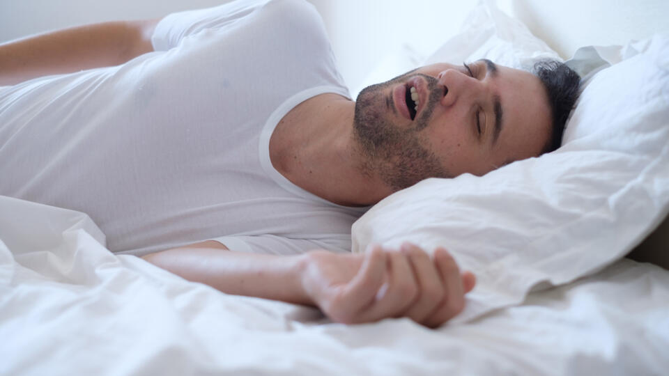 Man,Snoring,Because,Of,Sleep,Apnea,Lying,In,The,Bed