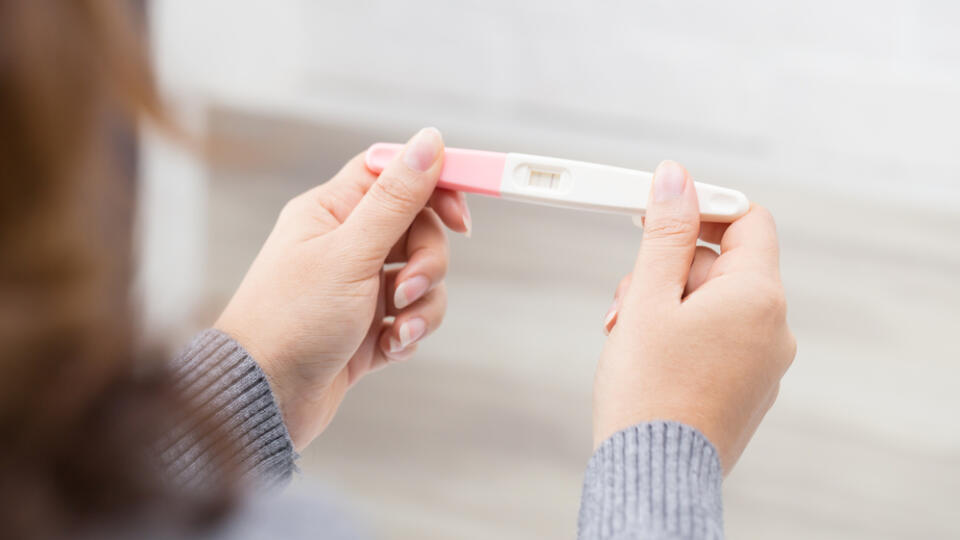 Woman,Holding,Pregnancy,Test,,New,Life,And,New,Family,Concept.