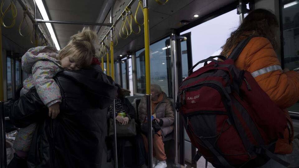 JB 28 Tel Aviv - Ukrajinka s dieťaťom na rukách nastupuje do kyvadlového autobusu na medzinárodnom letisku Ben Gurion v Tel Avive po ich prílete z Rumunska 8. marca 2022. Do Izraela v rámci mimoriadnych letov Operation Orange Wings pricestovala prvá skupina utečencov, ktorí utiekli z Ukrajiny pred ruskou vojenskou inváziou. FOTO TASR/AP
A Ukrainian toddler sleeps in her mother's arms on a shuttle bus after a special flight to Israel from Romania upon landing at Ben Gurion Airport, Tuesday, Marc