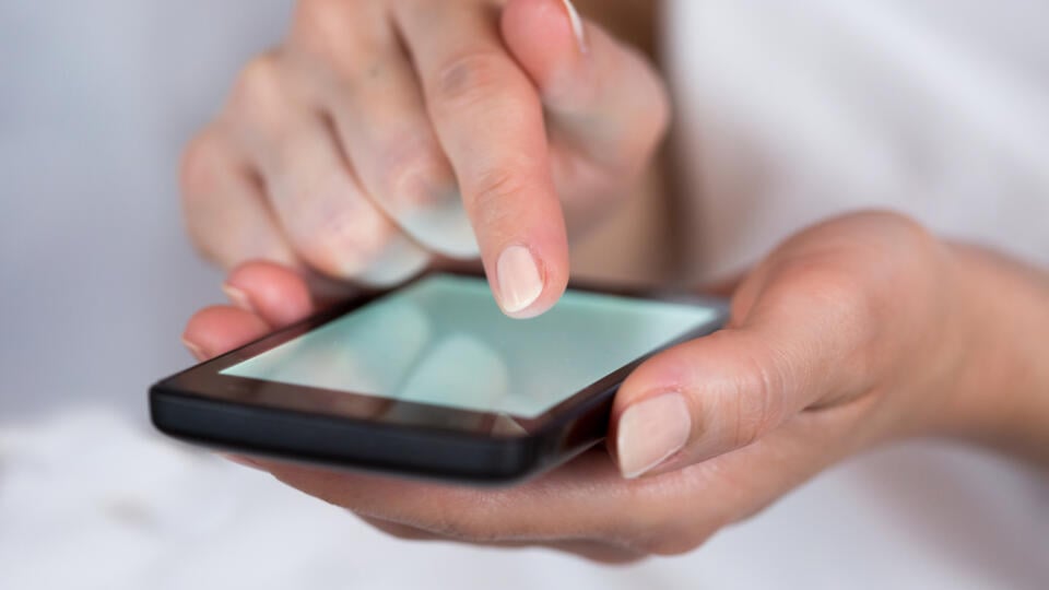 Hands,Holding,Smartphone,With,Glowing,Screen