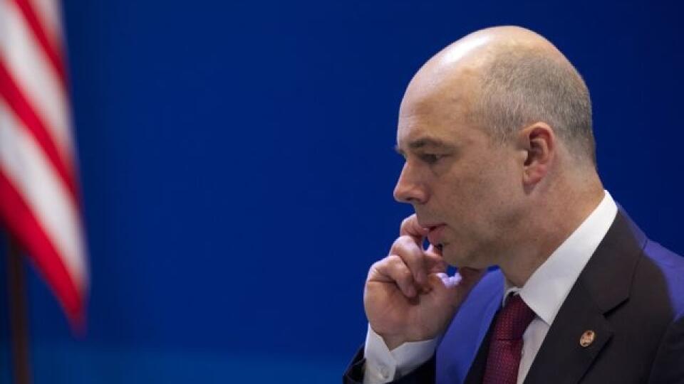 Russian Finance Minister Anton Siluanov speaks on a phone as he attends a group photo ceremony after a meeting of the Group of 20 finance ministers in Moscow, Russia, Saturday, July 20, 2013. The finance chiefs of the world's leading economies hope to force multinational companies to pay more taxes by closing loopholes that have allowed them to stash profits overseas. (AP Photo/Alexander Zemlianichenko)