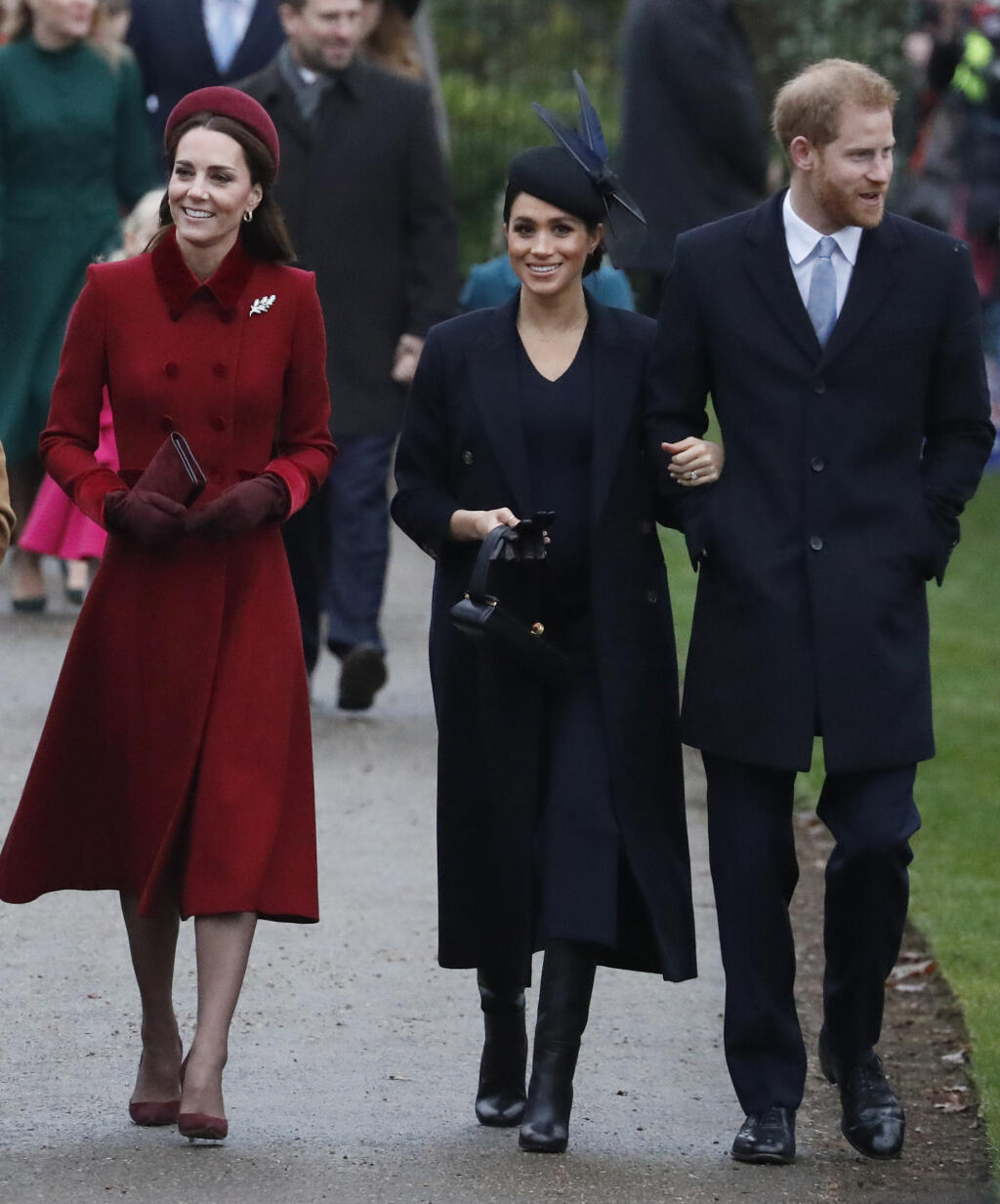 Britain's Kate, Duchess of Cambridge, left, Meghan Duchess of Sussex and Prince Harry, right, arrive to attend the Christmas day service at St Mary Magdalene Church in Sandringham in Norfolk, England, Tuesday, Dec. 25, 2018. (AP PhotoFrank Augstein)