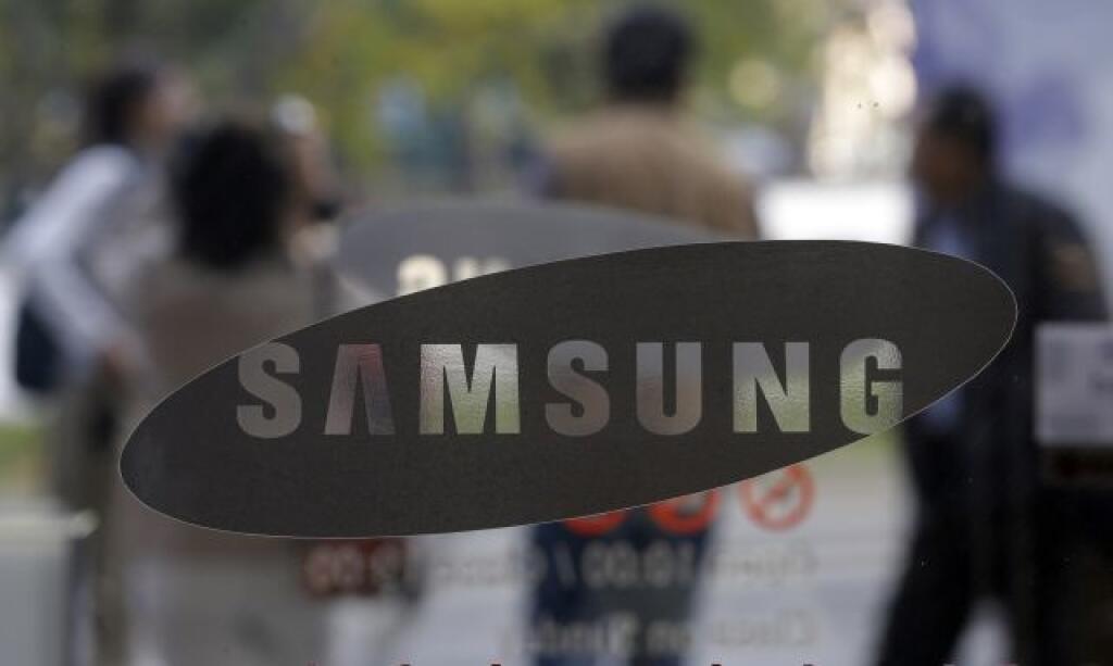 Visitors walk by the entrance to the Samsung Electronics Co. showroom at its headquarters in Seoul, South Korea, Friday, Oct. 26, 2012. Samsung's third-quarter net profit nearly doubled over a year earlier to a record high propelled by strong sales of Galaxy phones that helped widen its lead over rivals. (AP Photo/Lee Jin-man)