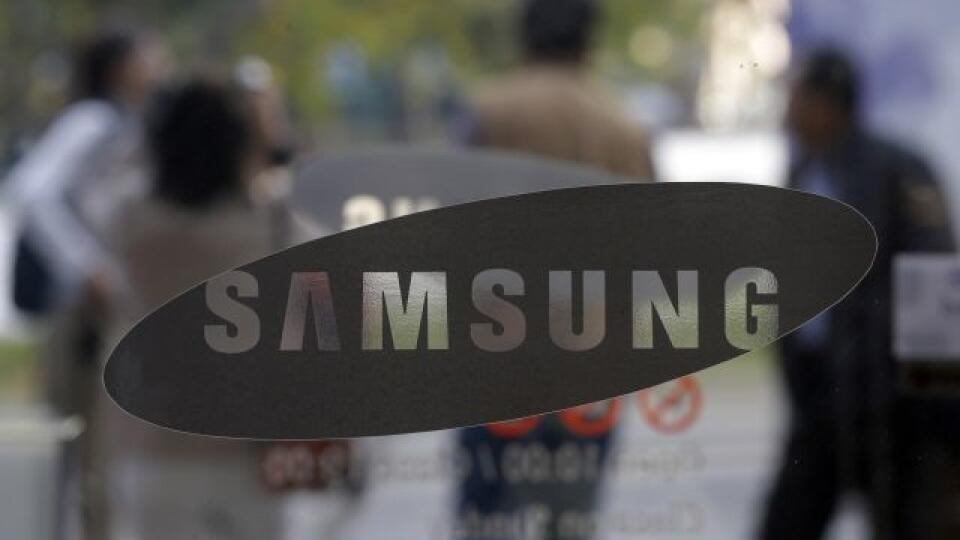 Visitors walk by the entrance to the Samsung Electronics Co. showroom at its headquarters in Seoul, South Korea, Friday, Oct. 26, 2012. Samsung's third-quarter net profit nearly doubled over a year earlier to a record high propelled by strong sales of Galaxy phones that helped widen its lead over rivals. (AP Photo/Lee Jin-man)