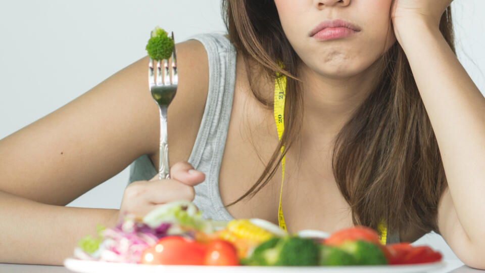 Unhappy,Asian,Women,Is,On,Dieting,Time,Looking,At,Broccoli