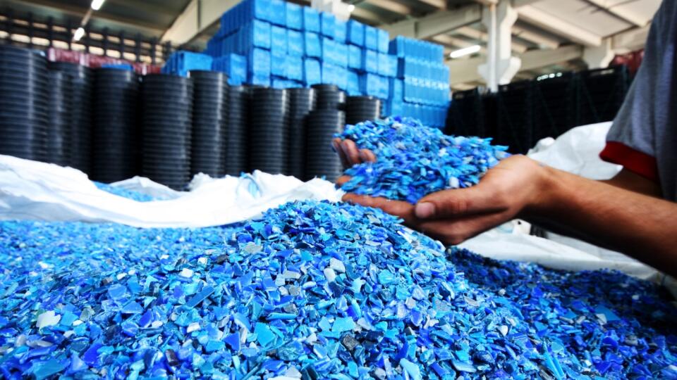 Plastic Resin pellets in holding hands.